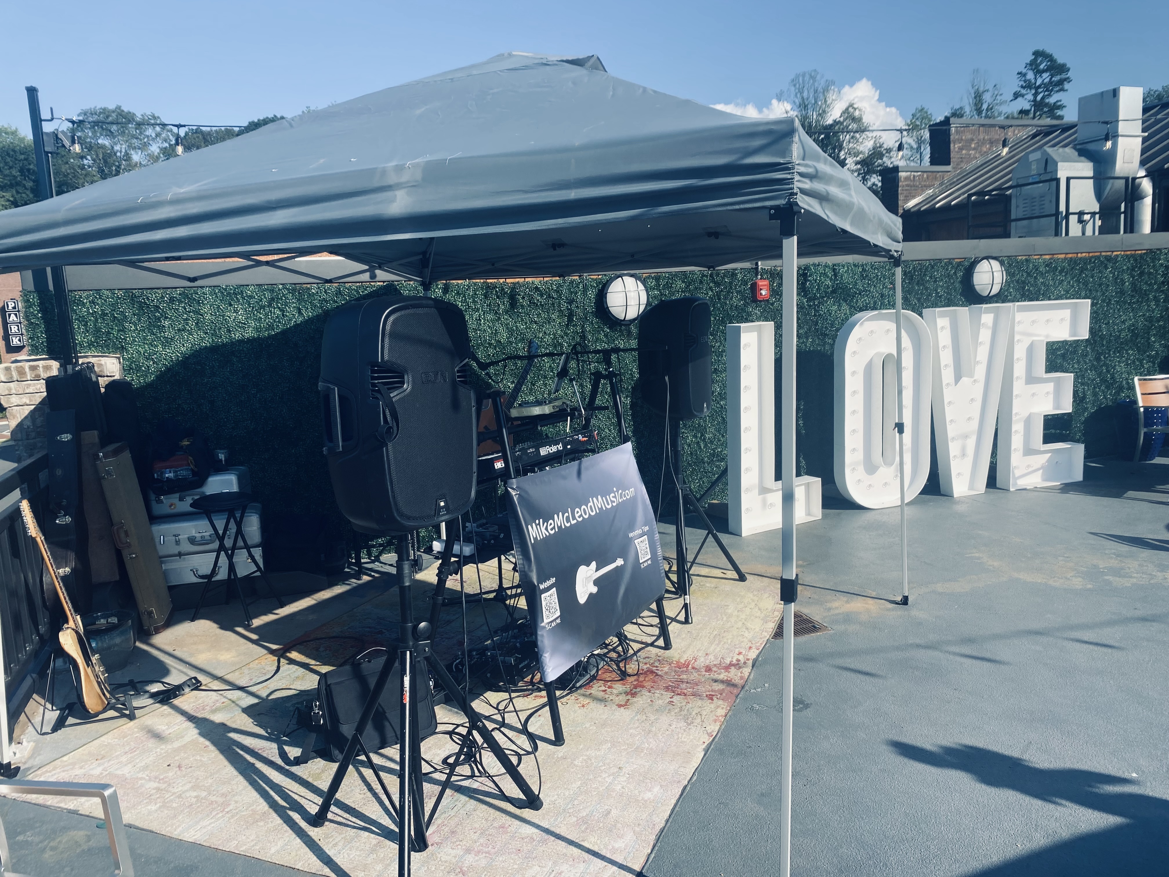 Mike McLeod stage setup with large marquee LOVE letters